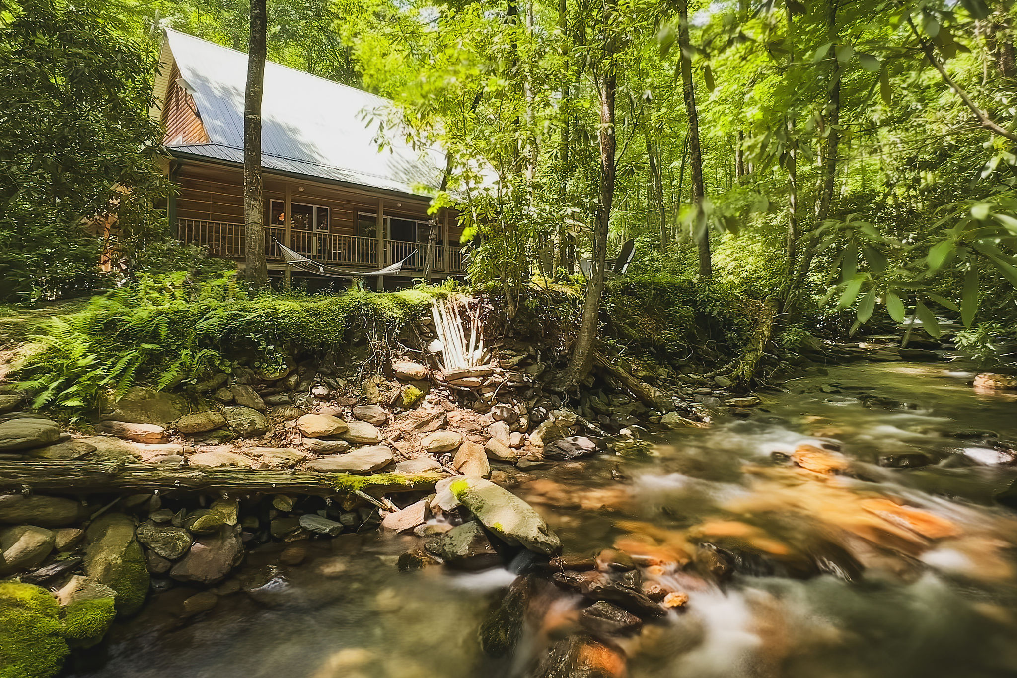 Compass Creek Cabin exterior with creek